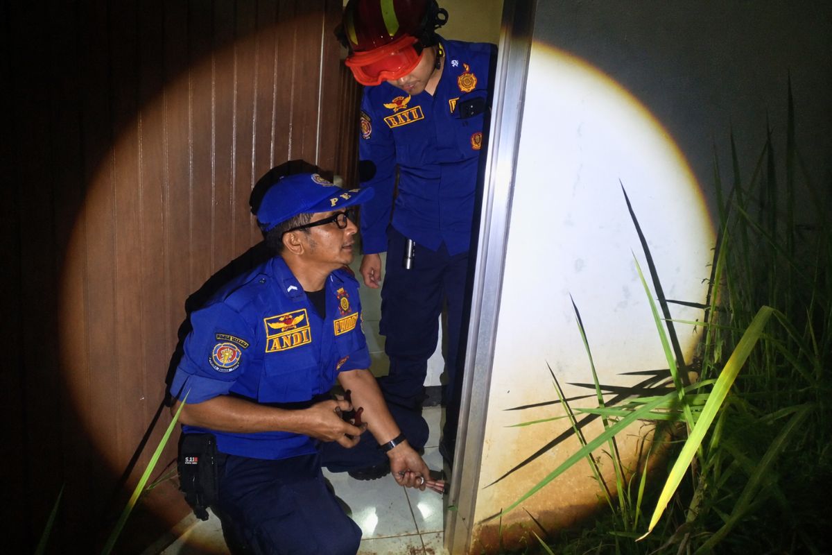 Petugas UPT Damkar Ciamis memperbaiki pintu rumah milik warga di Perum Sukma Hill, Kecamatan Baregbeg, sehingga kembali dapat dikunci dengan aman, Senin (27/7/2026) malam. Shotlist.id/Foto: Istimewa